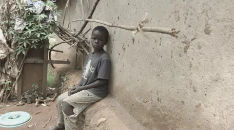 Boy in Kenya Africa poverty panning FLAT UNGRADED Stock Footage