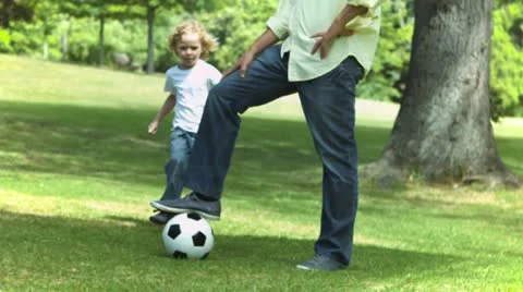 Boy kicking the ball in slow motion Stock Footage