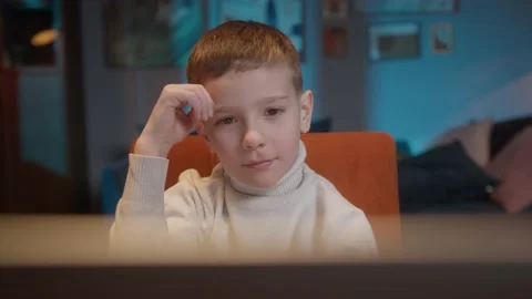 Boy kid making video call with laptop at home, using camera zoom online virtual Stock Footage 148750377