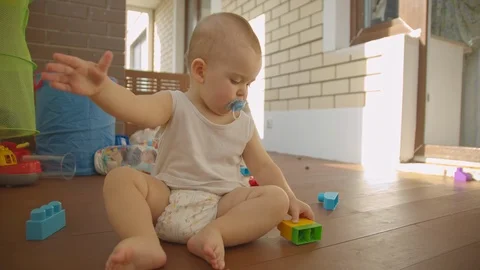 Boy kid playing with the designer on the balcony Stock Footage 114612988