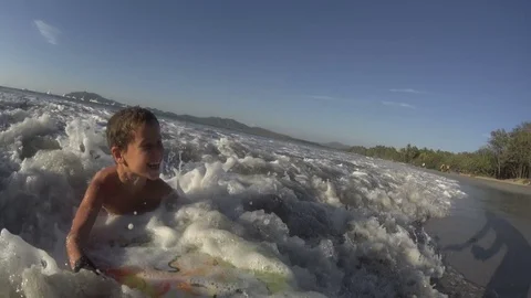 Boy / kid surfing - jumping waves Body Board at the beach, surfing, surf Stock Footage 76755877