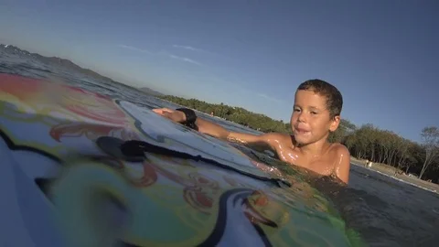 Boy / kid surfing - jumping waves Body Board at the beach, surfing, surf Stock-Footage 76757578