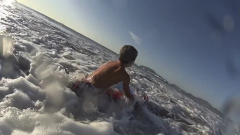 Boy / kid surfing - jumping waves Body Board 4k Stock Footage 77029803