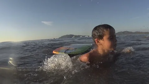 Boy / kid swimming - jumping waves Body Board Stock Footage 77033185