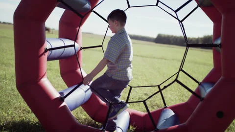 Boy Kid Walking and Playing in Rolling Cylinder Stock Footage 165593044