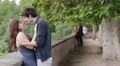 boy kissing beautiful girl , there is a mature couple in love in background HD Footage