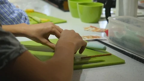 Boy in kitchen during cooking classes making cheese snacks Stock Footage 106393853