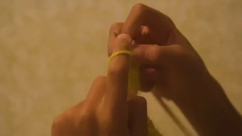 Boy is knitting a scarf with knitting needles. Learning how to knit. Homework Stock Footage 100719626