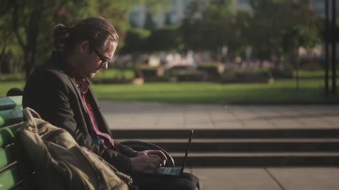 Boy with Laptop sitting in park Video stock 71632222