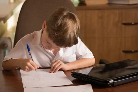 Boy with laptop at table Stock Photos