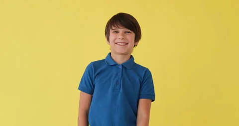 Boy laughing over yellow background Video stock 145237194