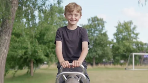 A Boy is Laughing on a Seesaw Slow Motion 库存影片 346203194