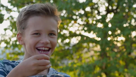 Boy Laughs While Eating a Blackberry Stock Footage 314443118