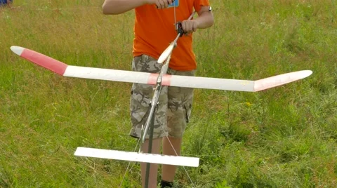 Boy is Launching Rubber Airplane Model Aircraft Model Sports Competition Stock Footage 64580573