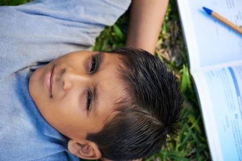Boy lay on grass Stock Photos