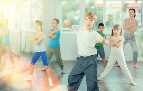 Boy learn to dance modern dances, repeat movement with unrecognizable teacher. Foto stock