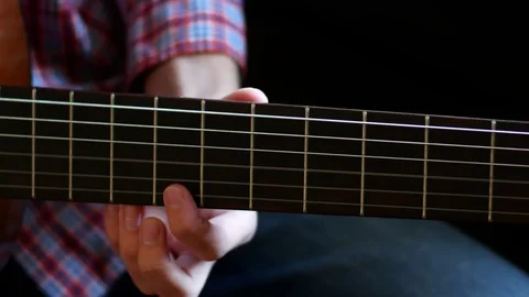 Boy learn how to play on classic guitar. Close up. Fingers touch the strings Video stock 112266278