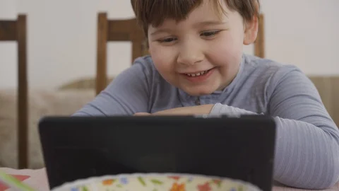 Boy learnin somethin fun on tablet. Personal learning. Online babysitter Video stock 127964254