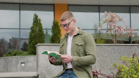 Boy Learning and Reading Outside Stock Footage 278387113