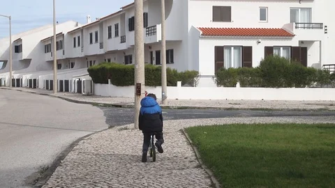 A boy learning to drive bicycle on the street Video stock 127976946
