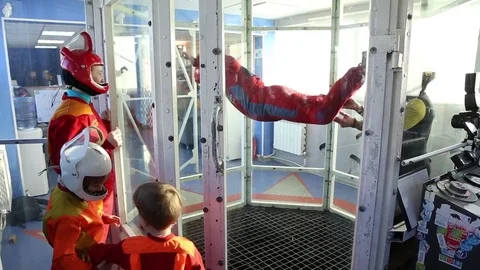 Boy learning to fly in aero tube Stock Footage 69870891