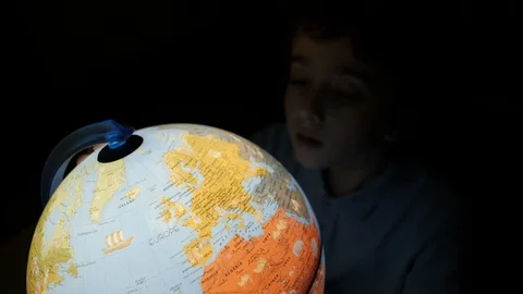 Boy learning geography on the globe at home  Stock Footage 102561593