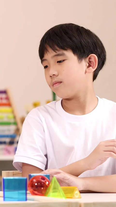 Boy Learning Geometry with Colorful Classroom STEM Blocks Stock Footage 328083642
