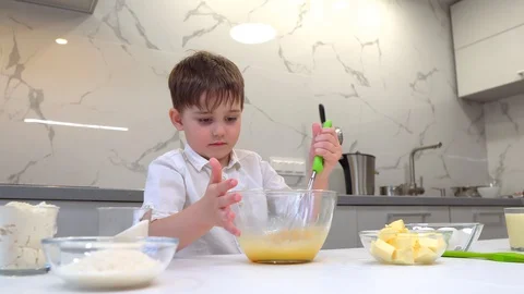 Boy learning how to make cookies at culinary workshop, holding whisker while Video stock 128834154