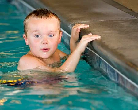 Boy learning how to swim Stock Photos