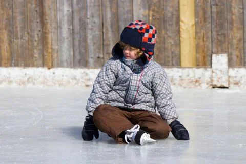 Boy learning to ice skate Stock Photos