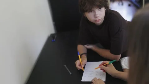Boy learning math with teachers help Stock Footage 311503070