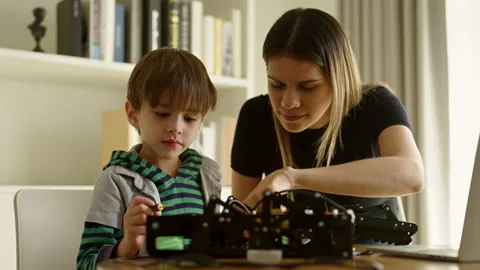 Boy learning online in coding robot car and electronic board in STEM Stock Footage 237524174