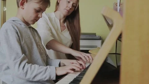 Boy Learning To Play Piano Stock Footage 150019733