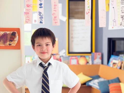 Boy Learning To Read From Hanging Paper Strip In Class Stock Photos
