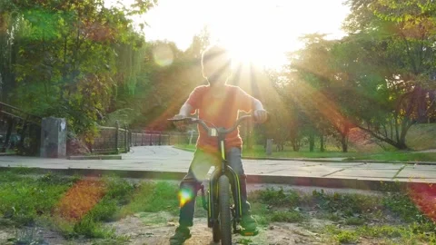 Boy learning to ride a bike Stock Footage 140124371