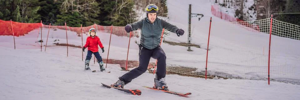 Boy learning to ski, training and listening to his ski instructor on the slope Stock Photos