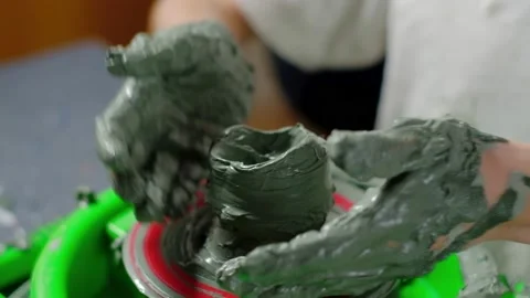 Boy learning to stick on a potter's wheel close-up Stock Footage 151642514