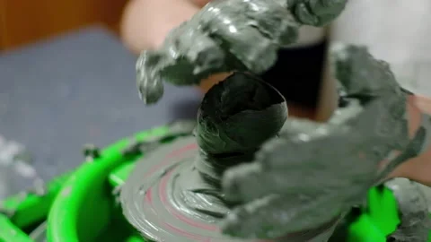 Boy learning to stick on a potter's wheel close-up Stock Footage 151642539
