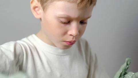 Boy learning to stick on a potter's wheel close-up Stock Footage 151642708
