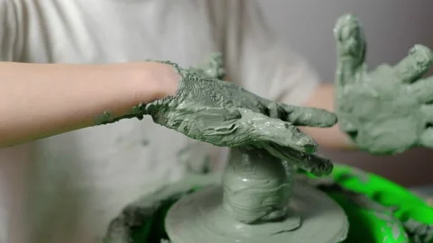 Boy learning to stick on a potter's wheel close-up Stock Footage 151642729