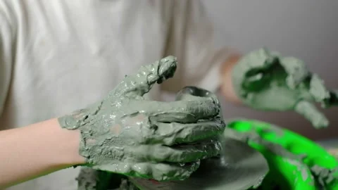 Boy learning to stick on a potter's wheel close-up Stock Footage 151642742