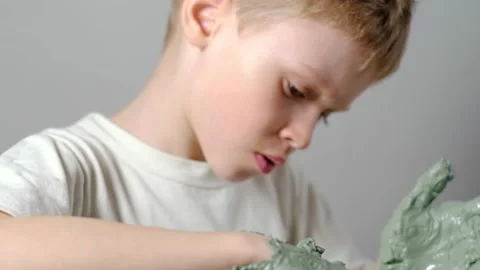 Boy learning to stick on a potter's wheel close-up Stock Footage 151642755
