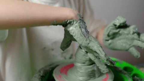Boy learning to stick on a potter's wheel close-up Stock Footage 151642825