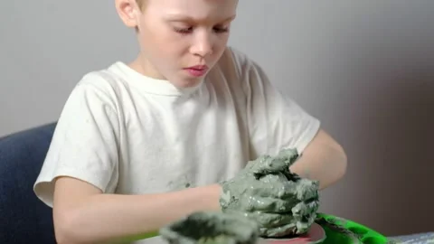 Boy learning to stick on a potter's wheel. Long or Wide Shot  Stock Footage 151642923