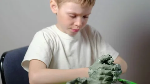 Boy learning to stick on a potter's wheel. Long or Wide Shot  Stock Footage 151642948