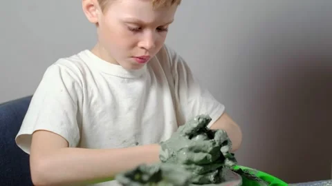 Boy learning to stick on a potter's wheel. Long or Wide Shot  Stock Footage 151642970