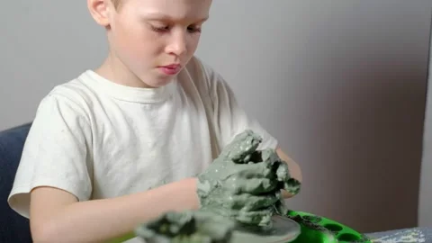 Boy learning to stick on a potter's wheel. Long or Wide Shot  動画素材 151643000