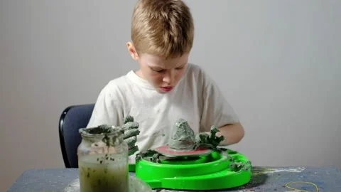 Boy learning to stick on a potter's wheel. Long or Wide Shot  Stock Footage 151643049