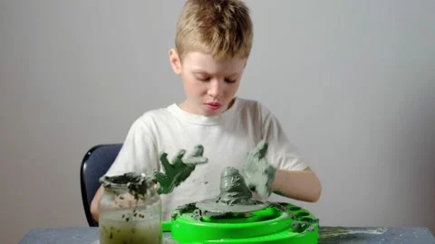 Boy learning to stick on a potter's wheel. Long or Wide Shot  Stock Footage 151643190