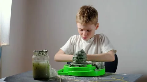 Boy learning to stick on a potter's wheel. Long or Wide Shot  Stock Footage 151643222